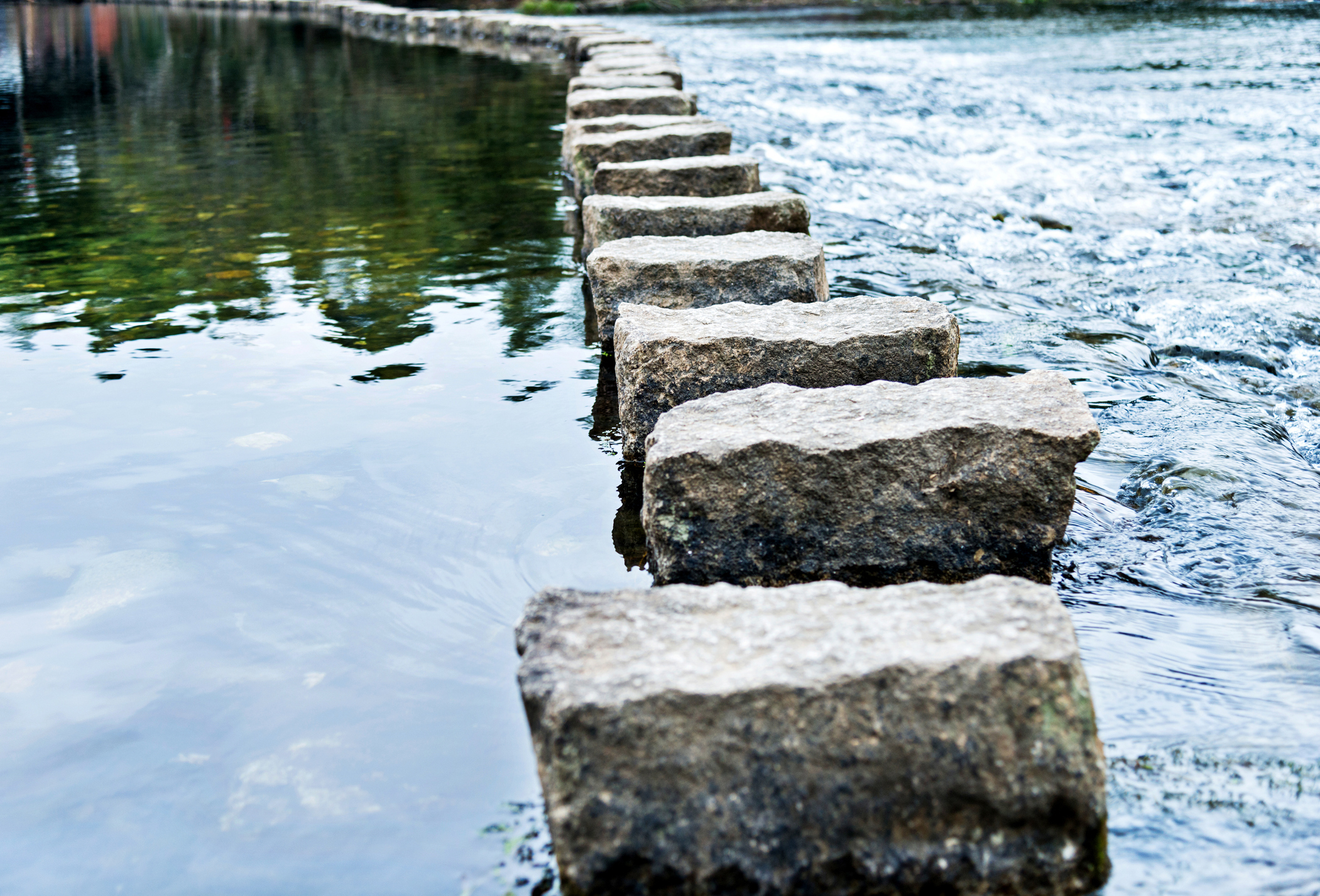 Stepping stones on the water stock photo